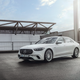 a white 2023 mercedes-amg s 63 e performance sedan seen from the front left, parked on the roof of a parking garage